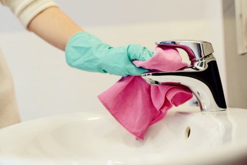 Cleaning specialist wearing PPE while treating a carpet