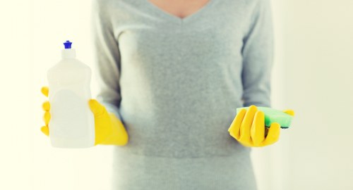 Cleaner maintaining shared hallway surfaces in a Bow apartment building