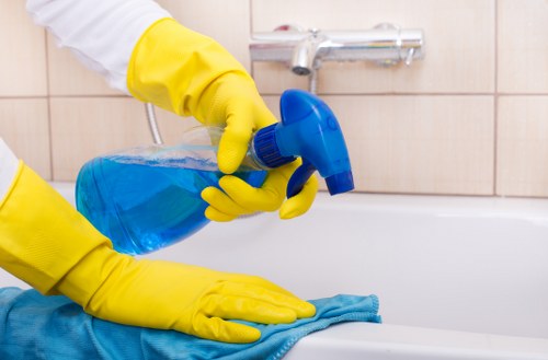 Cleaner inspecting fabric upholstery before treating stains in Bow